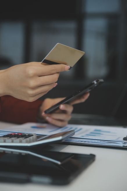 hand-holding-credit-card-using-laptop-businesswoman-entrepreneur-working-from-home-online-shopping-ecommerce-internet-banking-spending-money-work-from-home-concept (1)